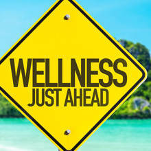 Wellness Just Ahead sign with beach background